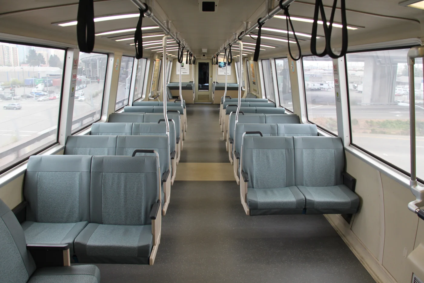 BART train interior with city streets visible through the windows. Photo by Maurits90, CC0.